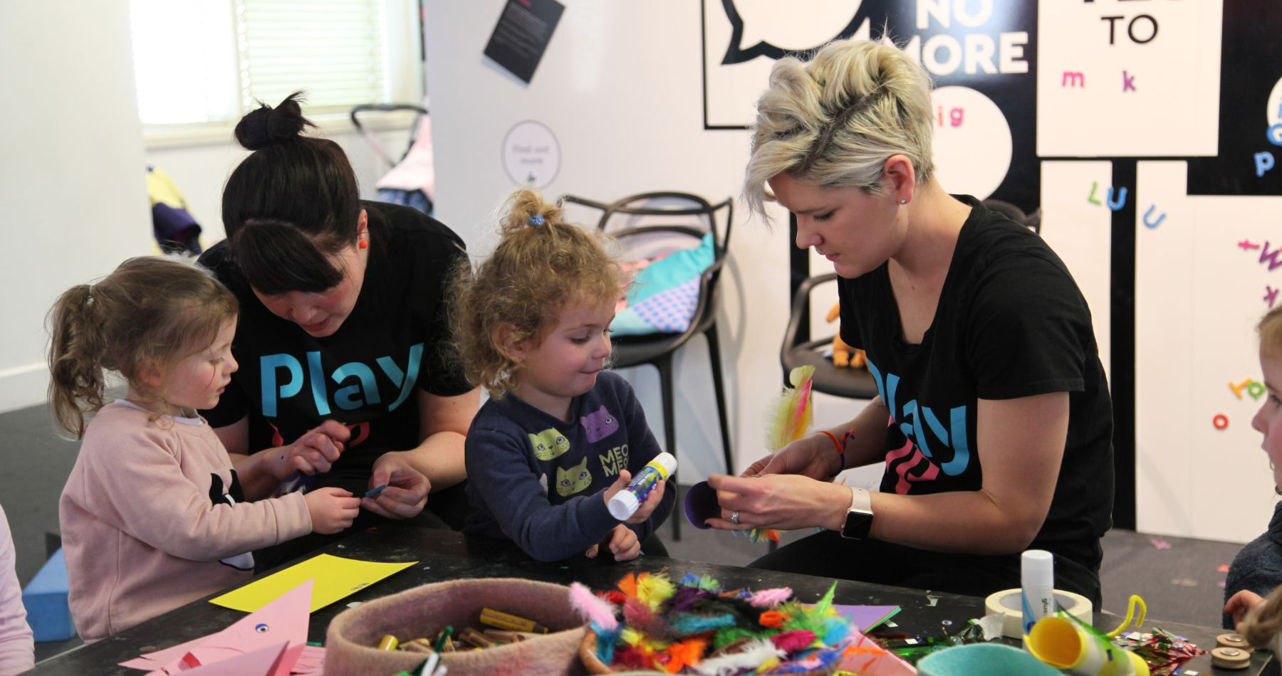 Two children playing with two PlayUP staff members Two children playing with two PlayUP staff members