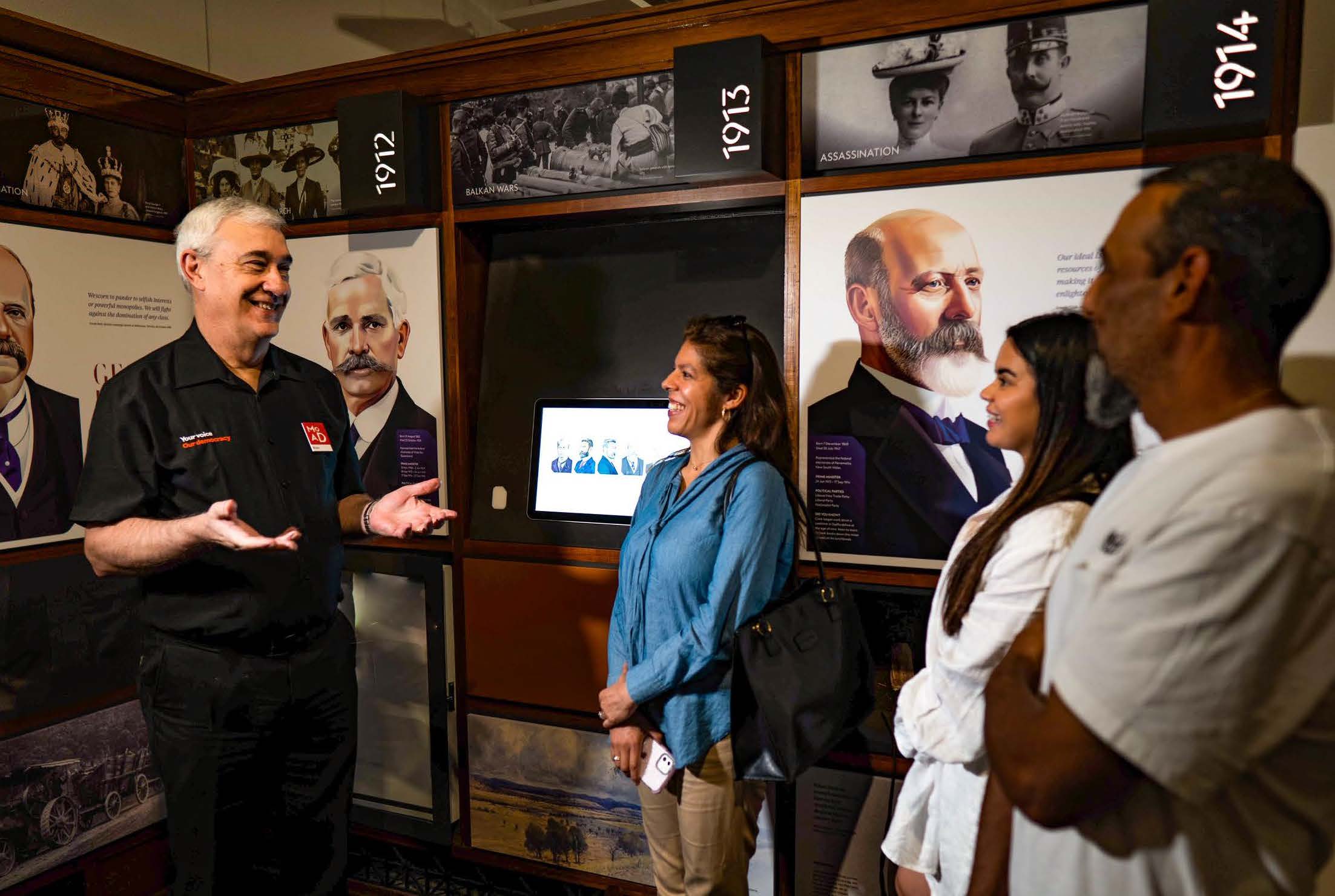 A tour guide talking to visitors to the museum