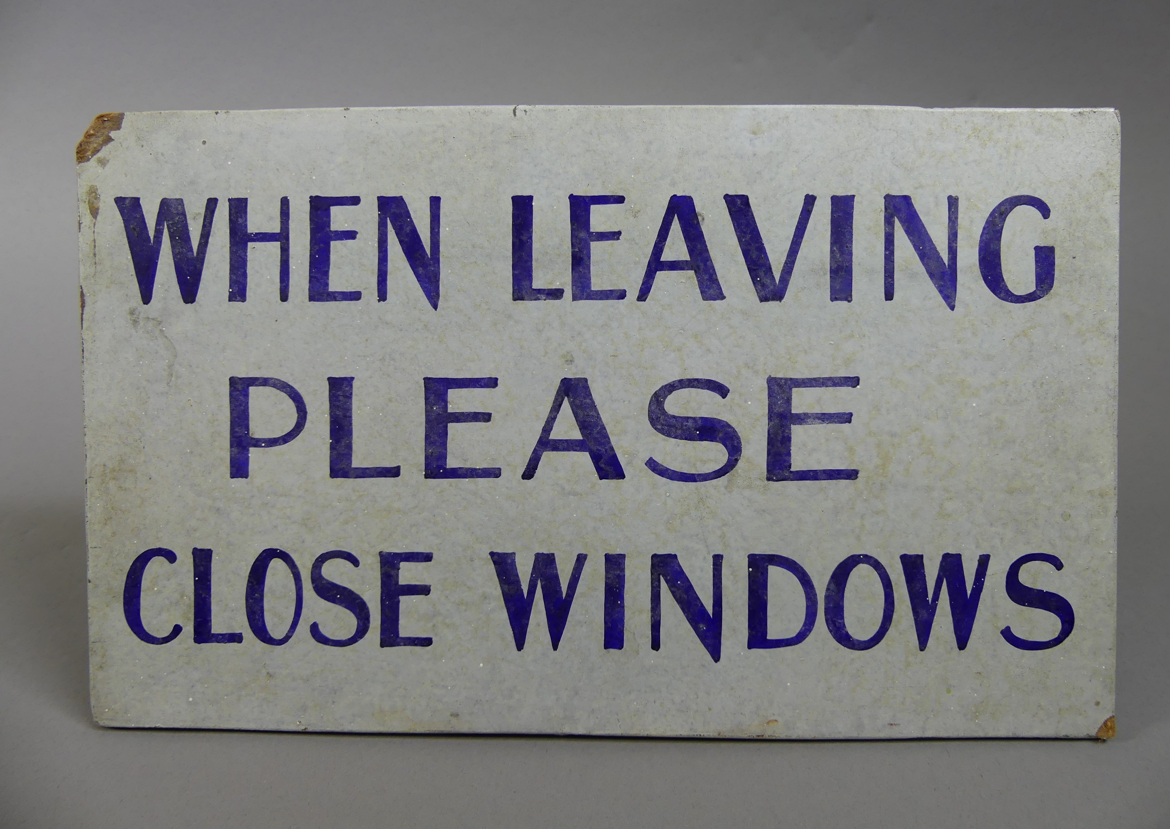 A handpainted sign that reads 'When leaving please close windows'