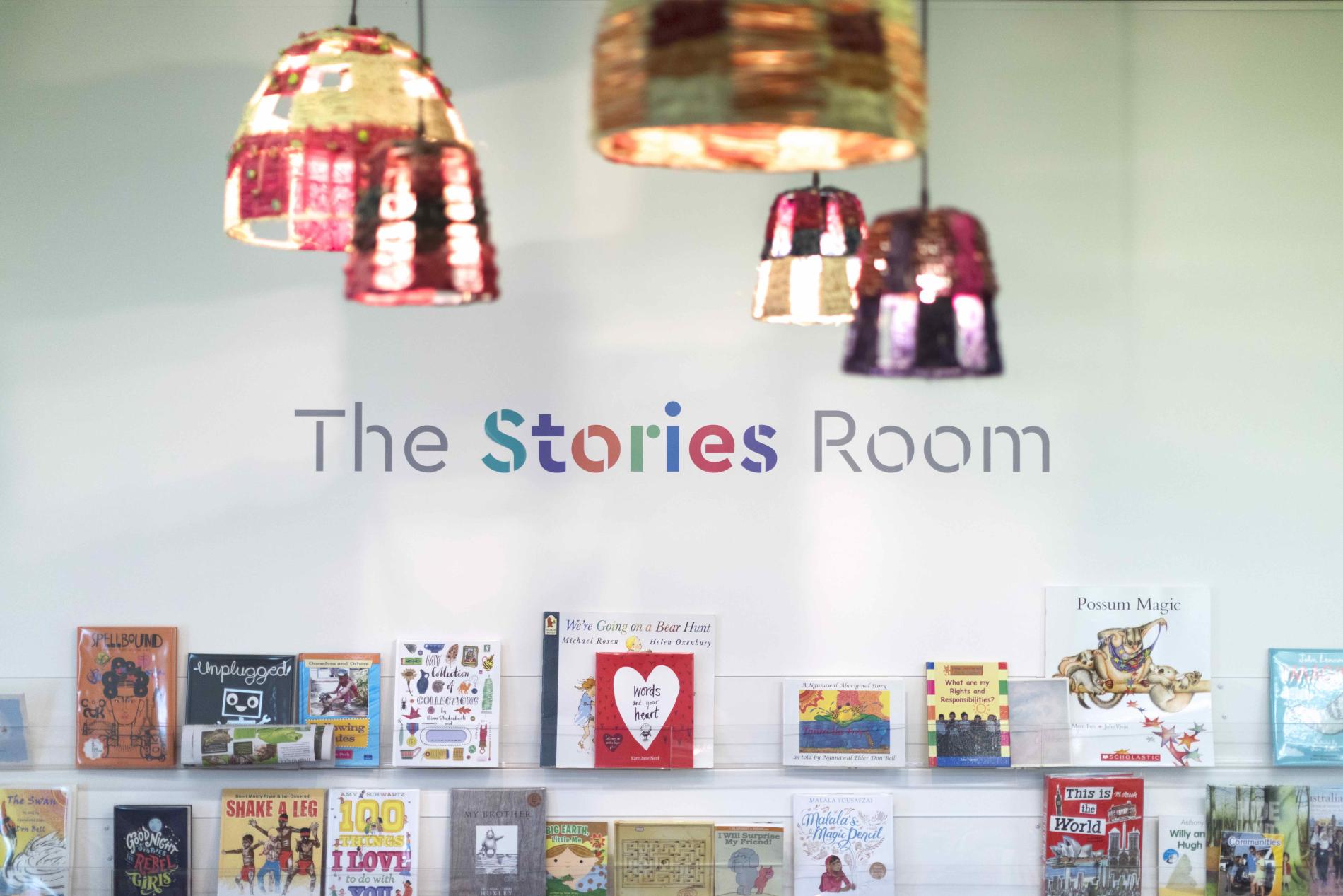 Picture books on a bookshelf with the words The Stories Room above.