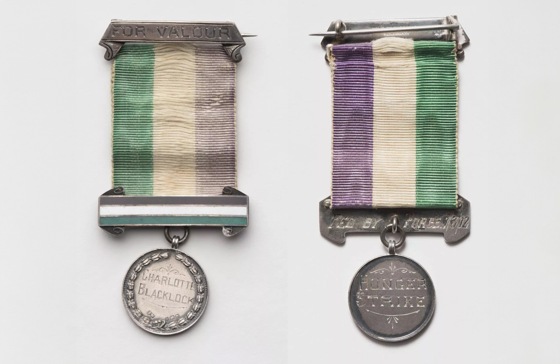 A round medal attached to a green, white and purple ribbon, etched onto the front the words 'For Valour' and 'Charlotte Blacklock', on the back 'Fed by force 1/3/12' and 'hunger strike'.