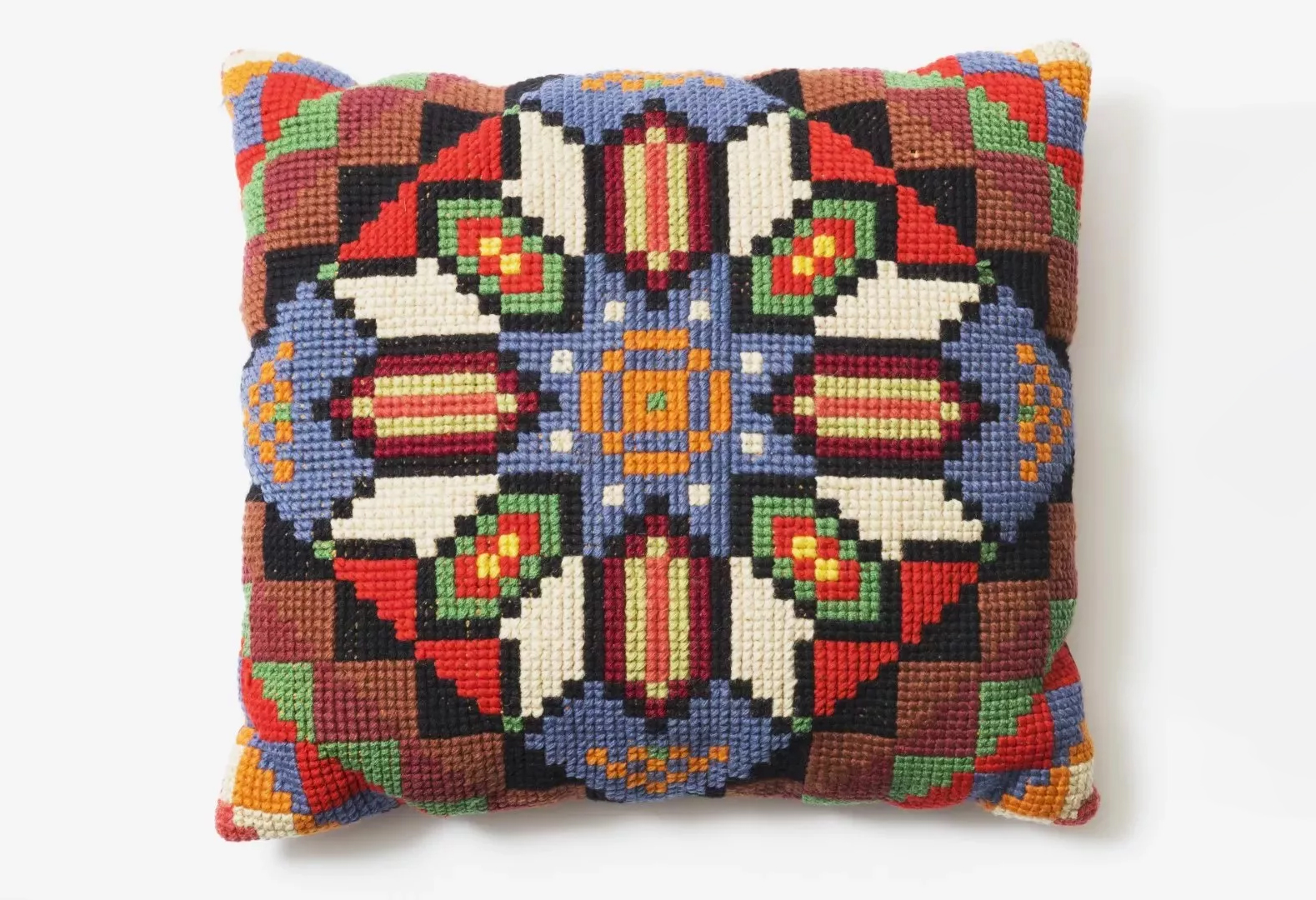 An embroidered multicoloured knitted cushion.