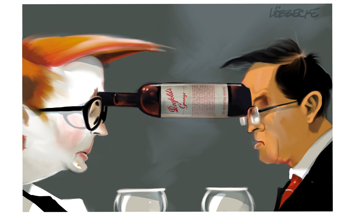 Marise Payne and the Chinese Ambassador to Australia face each other across two wine glasses. They are holding a horizontal wine bottle between them using their foreheads.