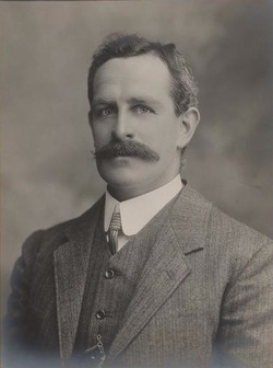 A scan of a black and white portrait image showing former prime minister Frank Tudor.