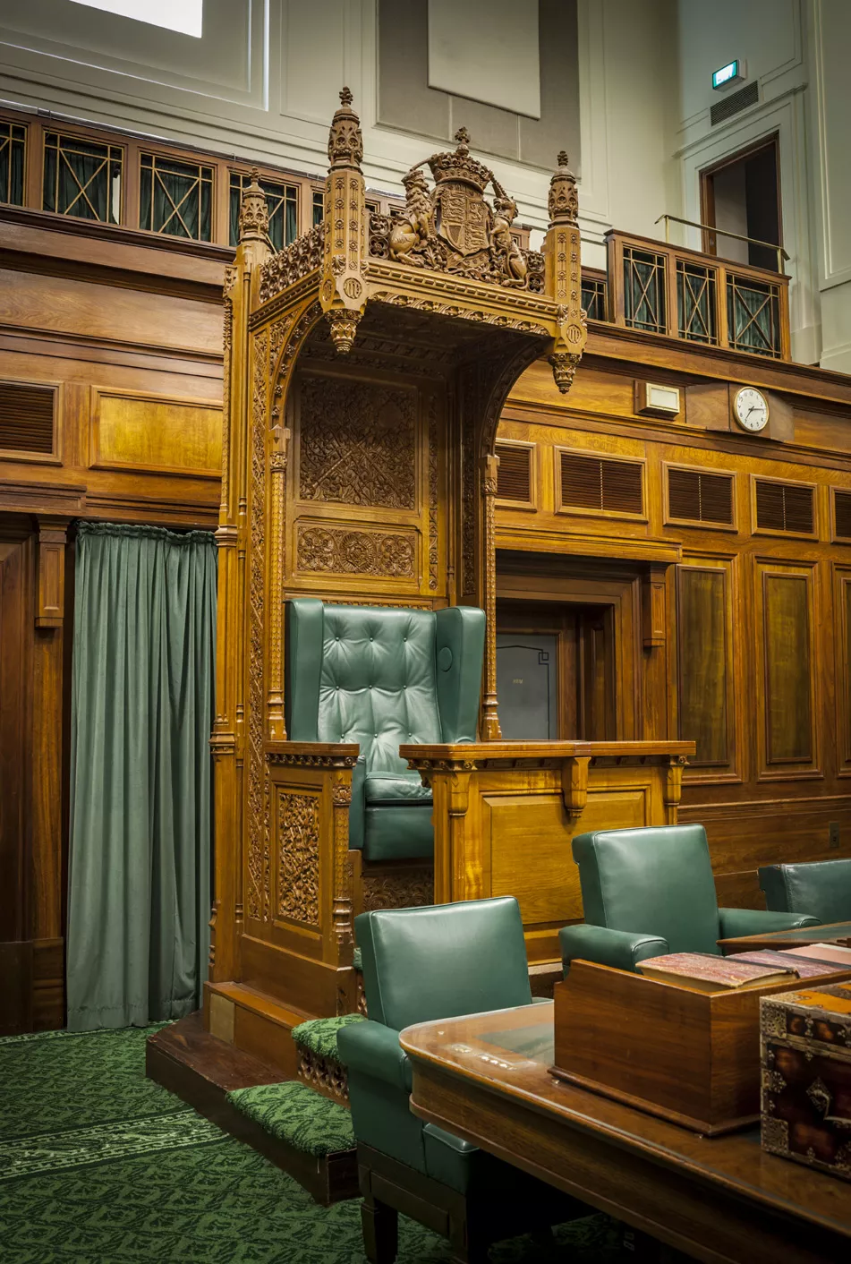 The Speaker's Chair is a large wooden ornate chair with green leather.