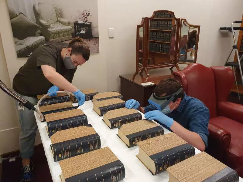 MoAD conservators painstakingly clean Hansard books from MoAD’s collection. MoAD conservators painstakingly clean Hansard books from MoAD’s collection.