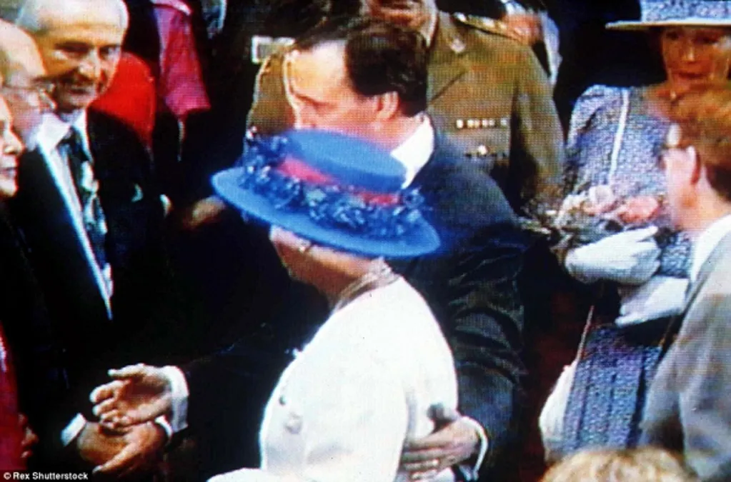 Keating walking next to the Queen guiding her with a hand on her back.