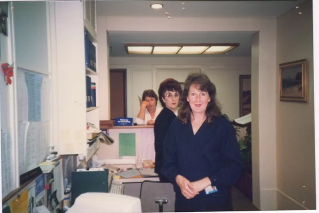 Staff members standing in a row, looking at the camera. 