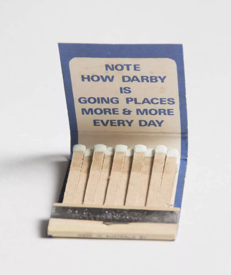 Photograph of an open matchbook with the matches inside.