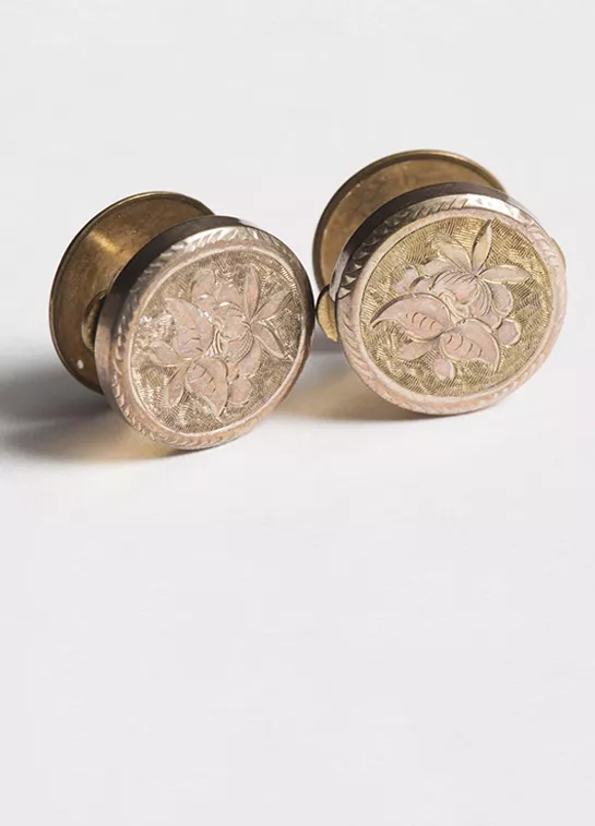 Photograph of two golden cufflinks