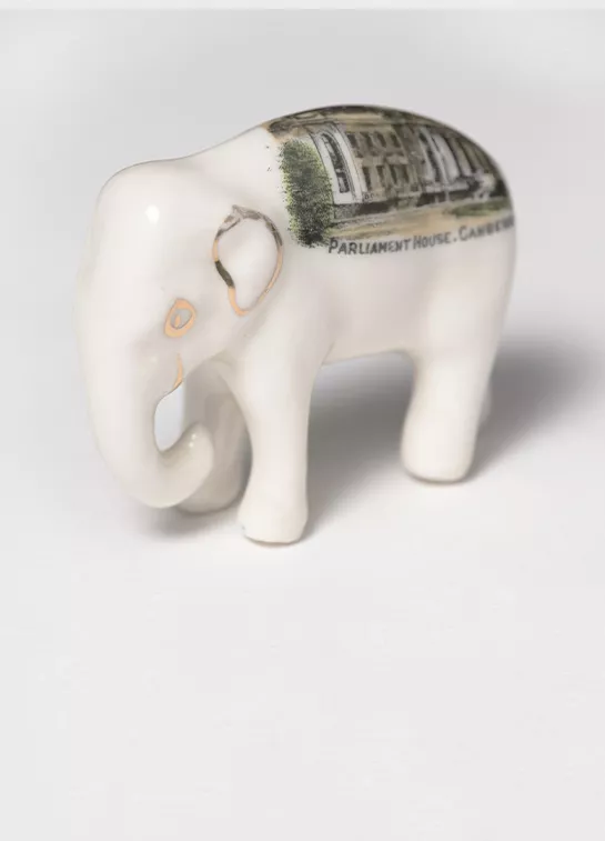 Photograph of a souvenir elephant with a painting of Provisional Parliament house on its back.