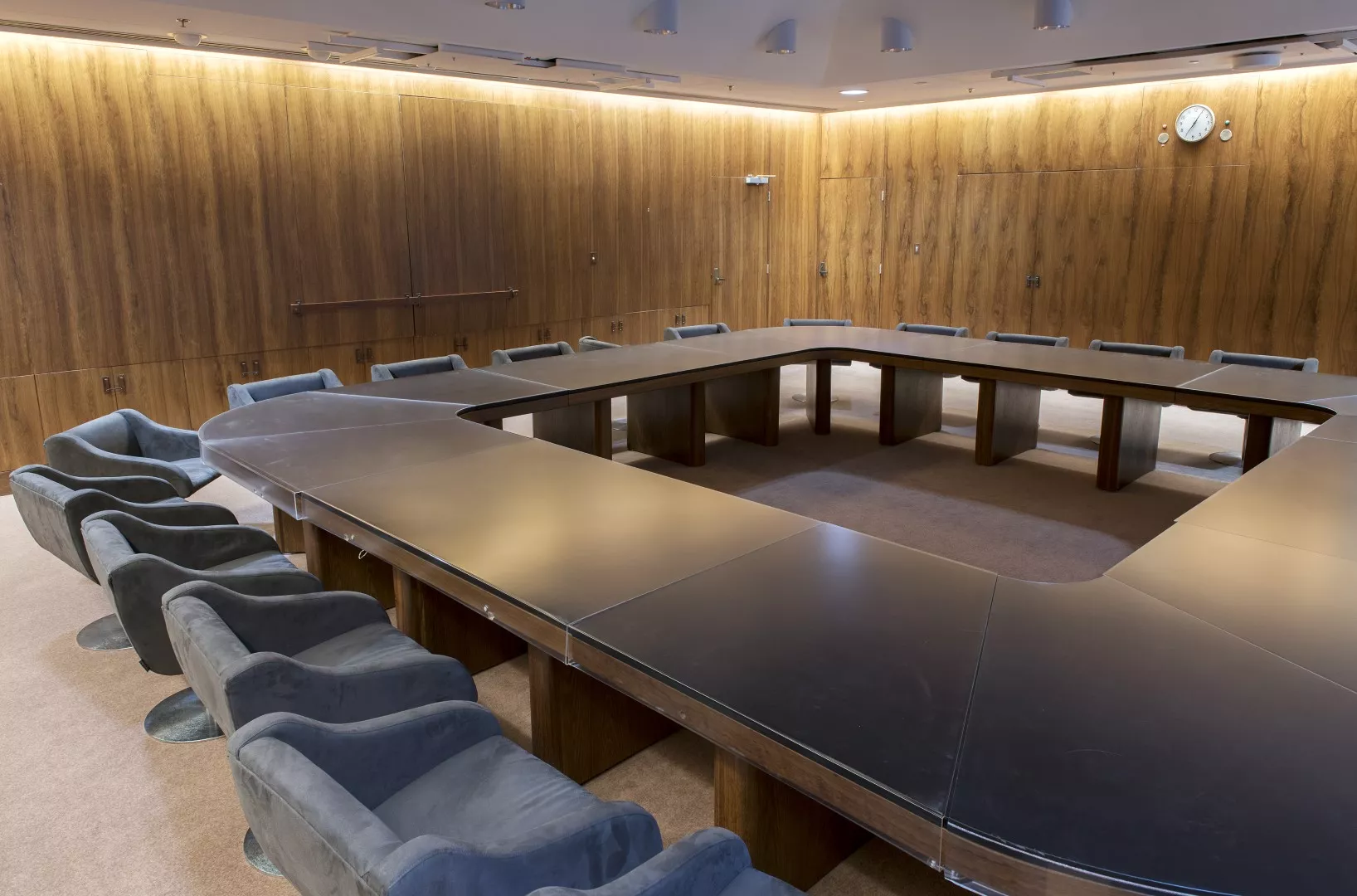 An oak table with black leather top surrounded by chairs in the Cabinet Room of Old Parliament House.