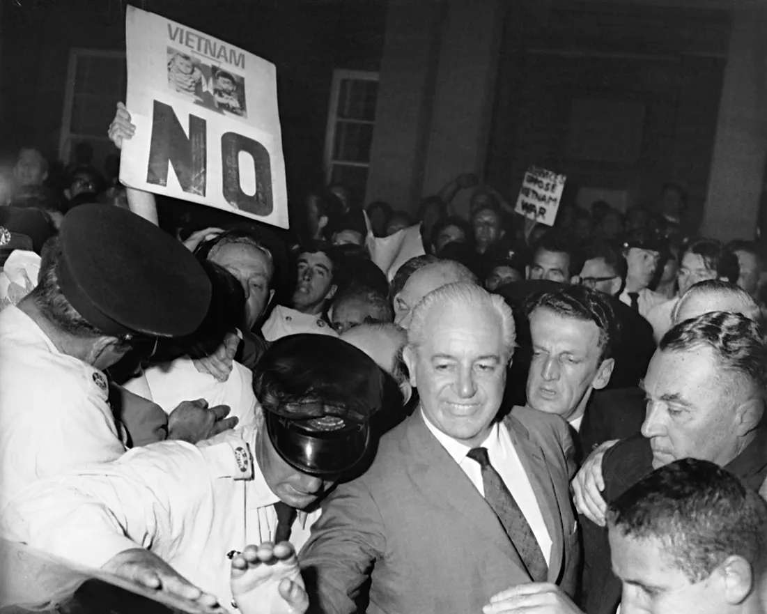 Harold Holt is jostled at a rally. 