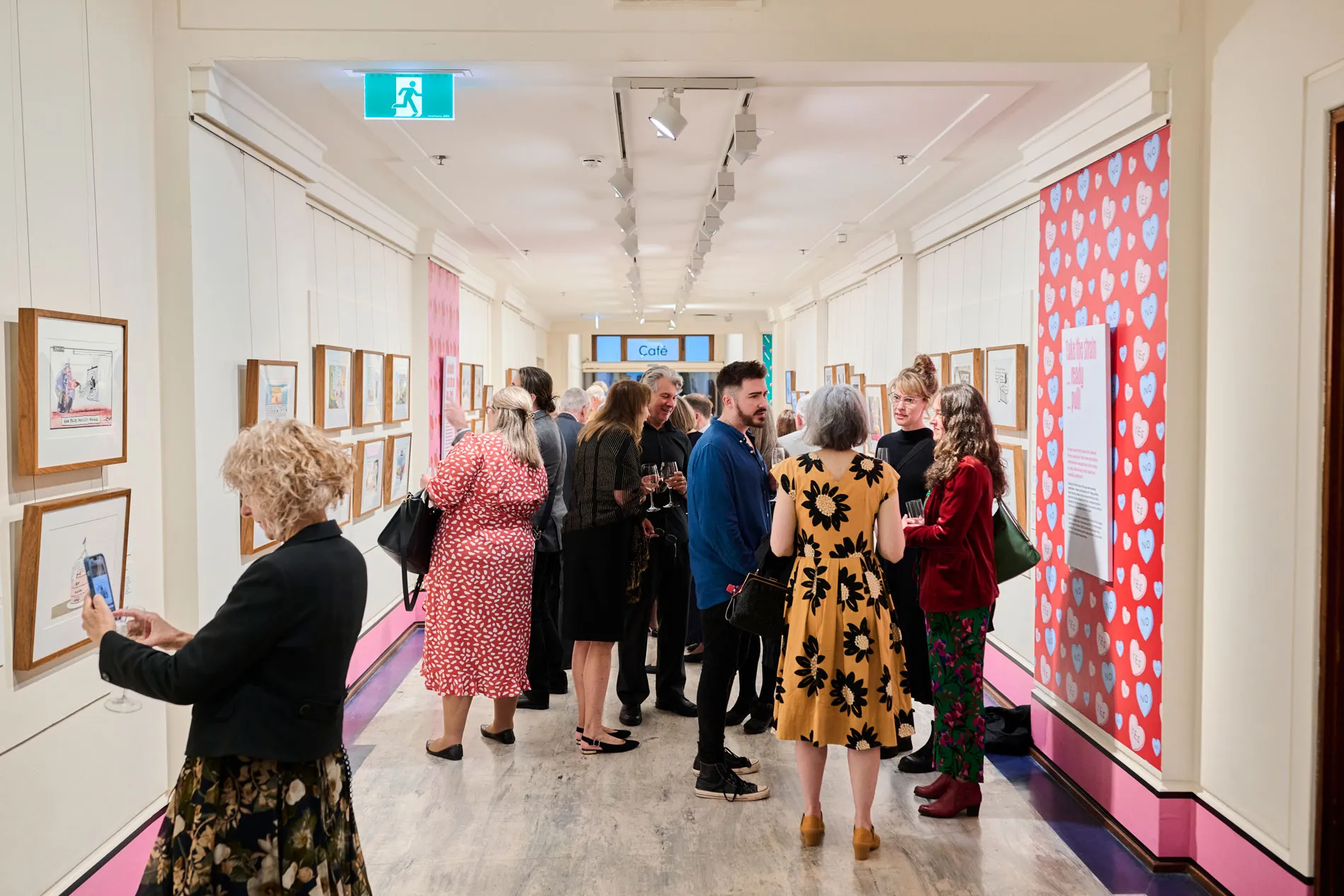 People viewing a political cartooning exhibition at Old Parliament House.