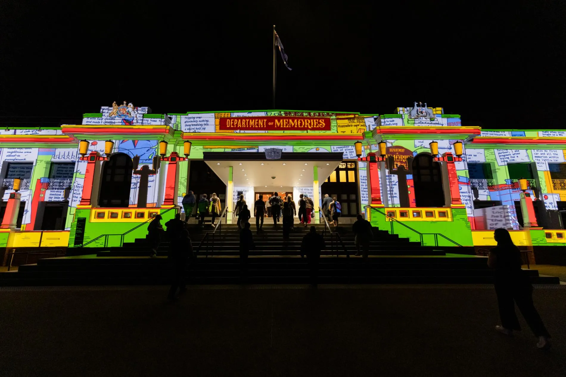The front of Old Parliament House illuminated with graphics, above the entry a graphic says 'Department of Memories'.