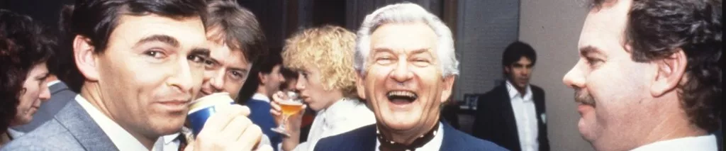MP John Brumby (left) and Prime Minister Bob Hawke (centre) join colleagues in the Senate Committee Room for a beer and a laugh.