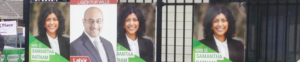 Election corflutes attached to a fence