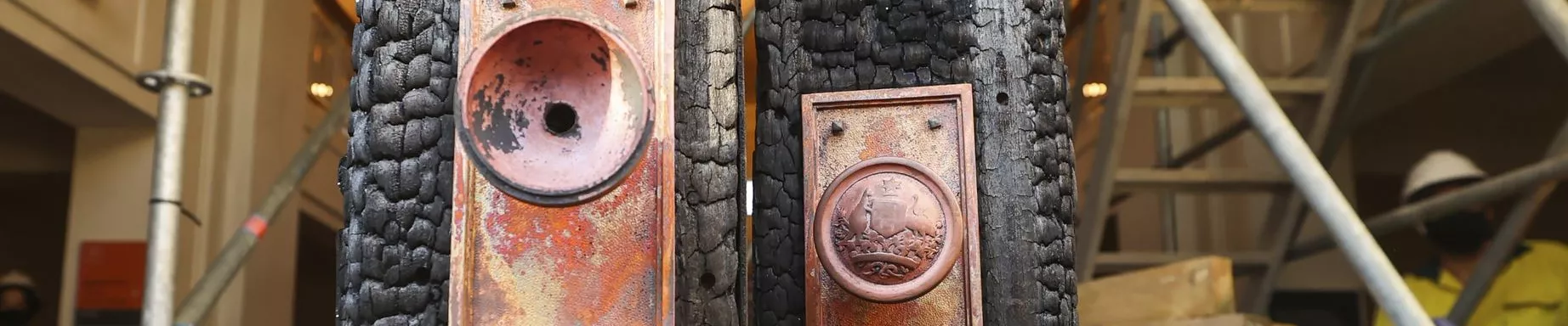 A photograph of the front doors of Old Parliament House, burnt from a fire