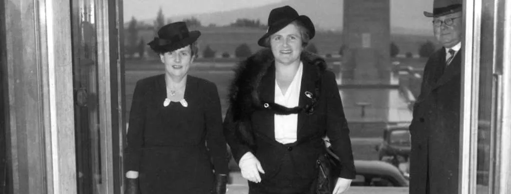 Dorothy Tangney and Enid Lyons walk through the front door of Old Parliament House together in 19423 smiling. 