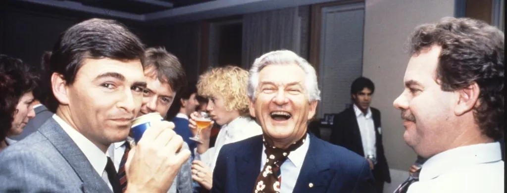 MP John Brumby (left) and Prime Minister Bob Hawke (centre) join colleagues in the Senate Committee Room for a beer and a laugh.