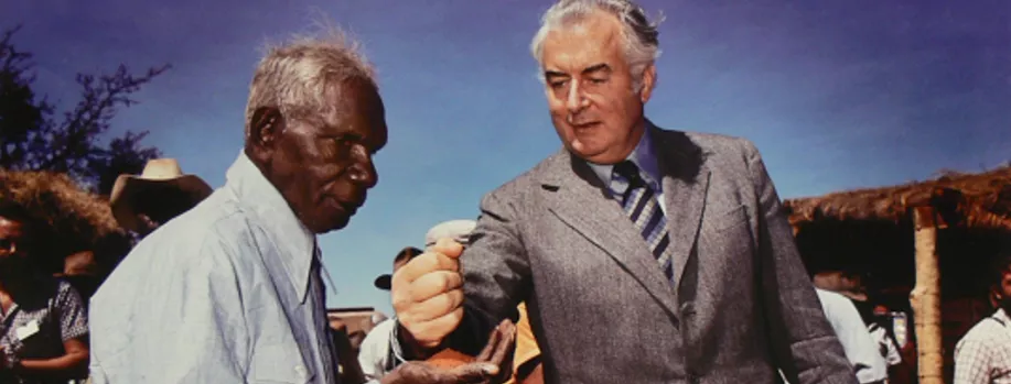 Gough Whitlam pouring earth through Vincent Lingiari’s hand