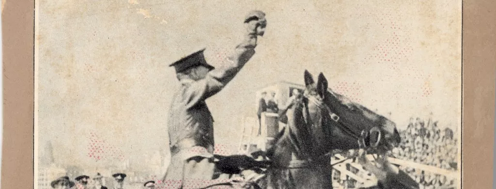Francis De Groot rides up on a horse, dressed in full military uniform