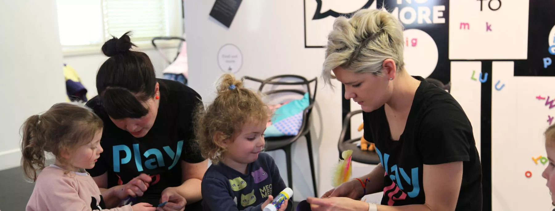 Two children playing with two PlayUP staff members