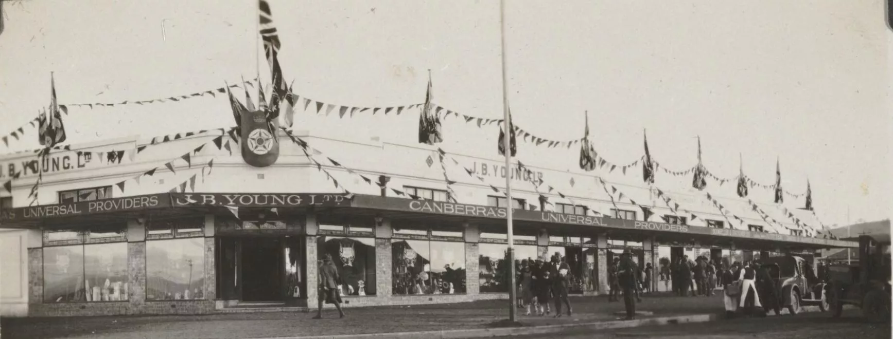 A department store, J B Young Ltd, decorated with flags and bunting.