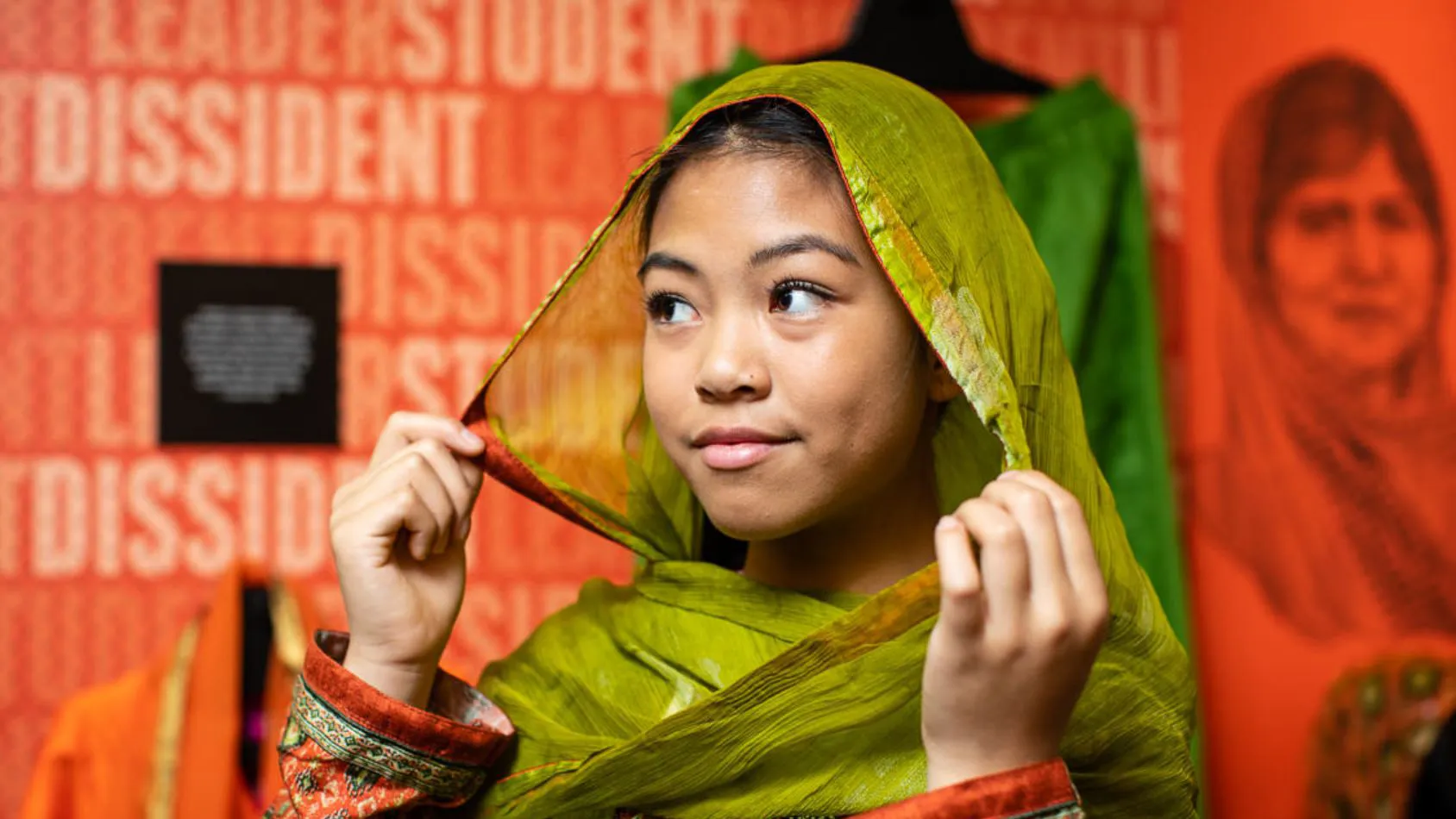 A young visitor trying on the exhibition outfits