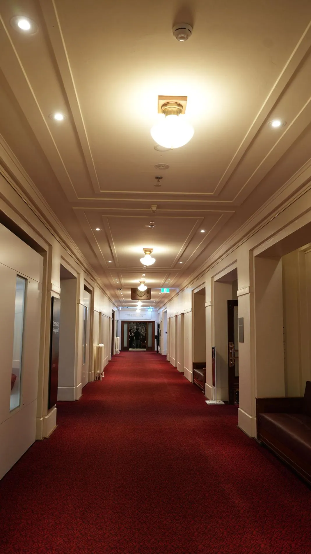 A hallway with red carpet in Old Parliament House.