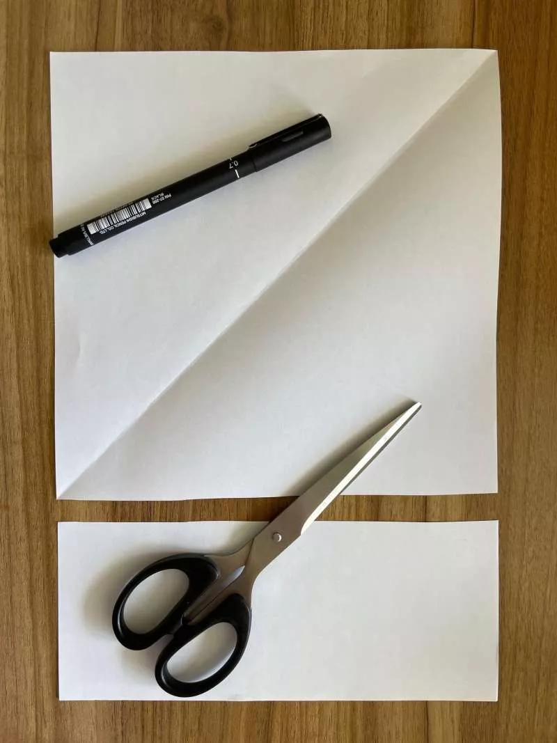 A rectangular piece of paper with the bottom cut off to make a square piece of paper. A rectangular piece of paper with the bottom cut off to make a square piece of paper.