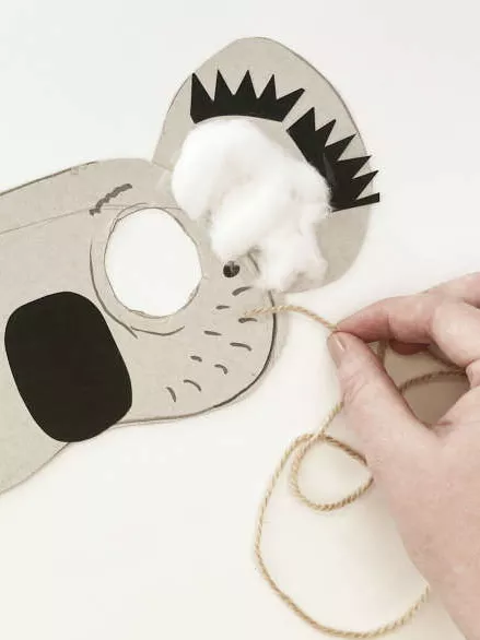A face mask of a koala with cotton wool in the ears. A face mask of a koala with cotton wool in the ears.