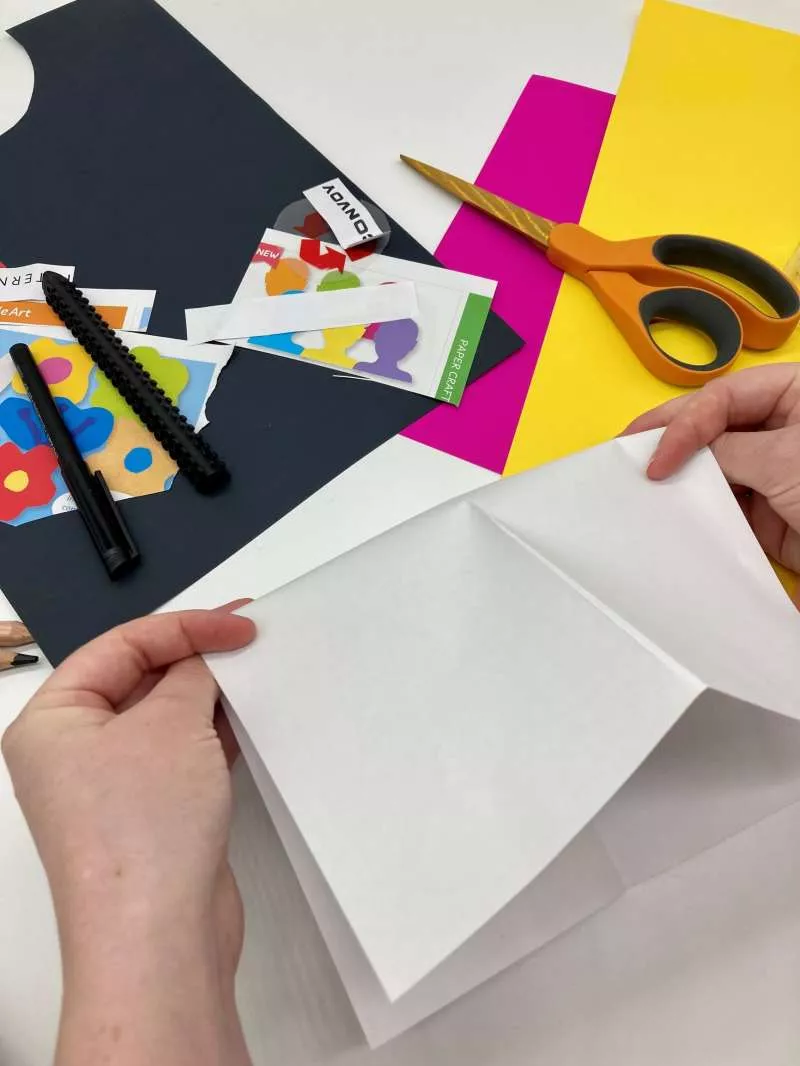 Two hands fold a piece of paper. Two hands fold a piece of paper.