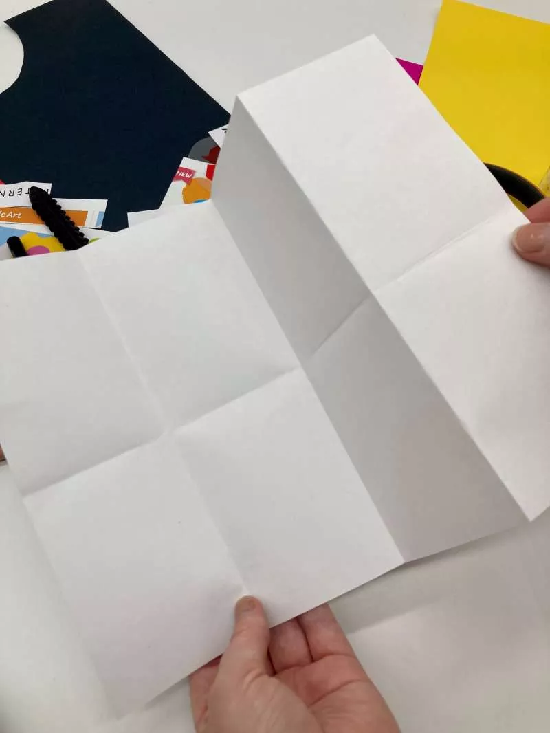 A piece of paper unfolded with creases indicating 8 sections. A piece of paper unfolded with creases indicating 8 sections.