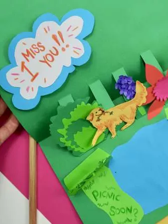 A colourful handmade card that features a lion in a forest next to a lake and the words 'I miss you'. A colourful handmade card that features a lion in a forest next to a lake and the words 'I miss you'.