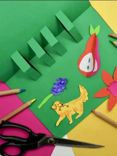 A green piece of paper with glue, pencils, textas and paper decorations. A green piece of paper with glue, pencils, textas and paper decorations.