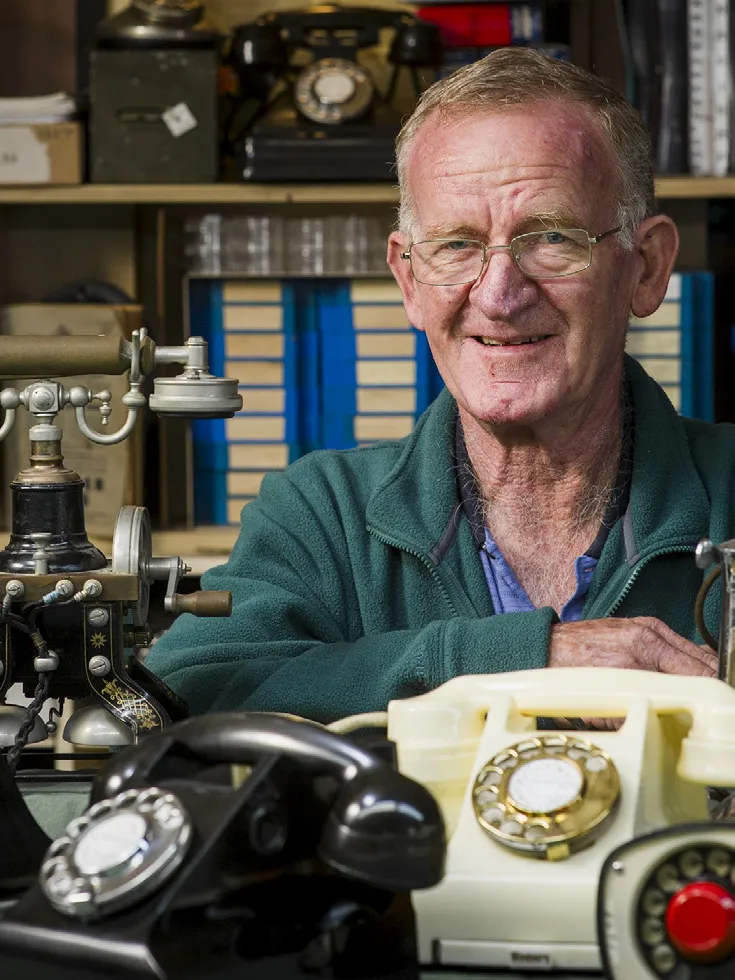 Neil Baker with a selection of telephones from the MoAD Collection.