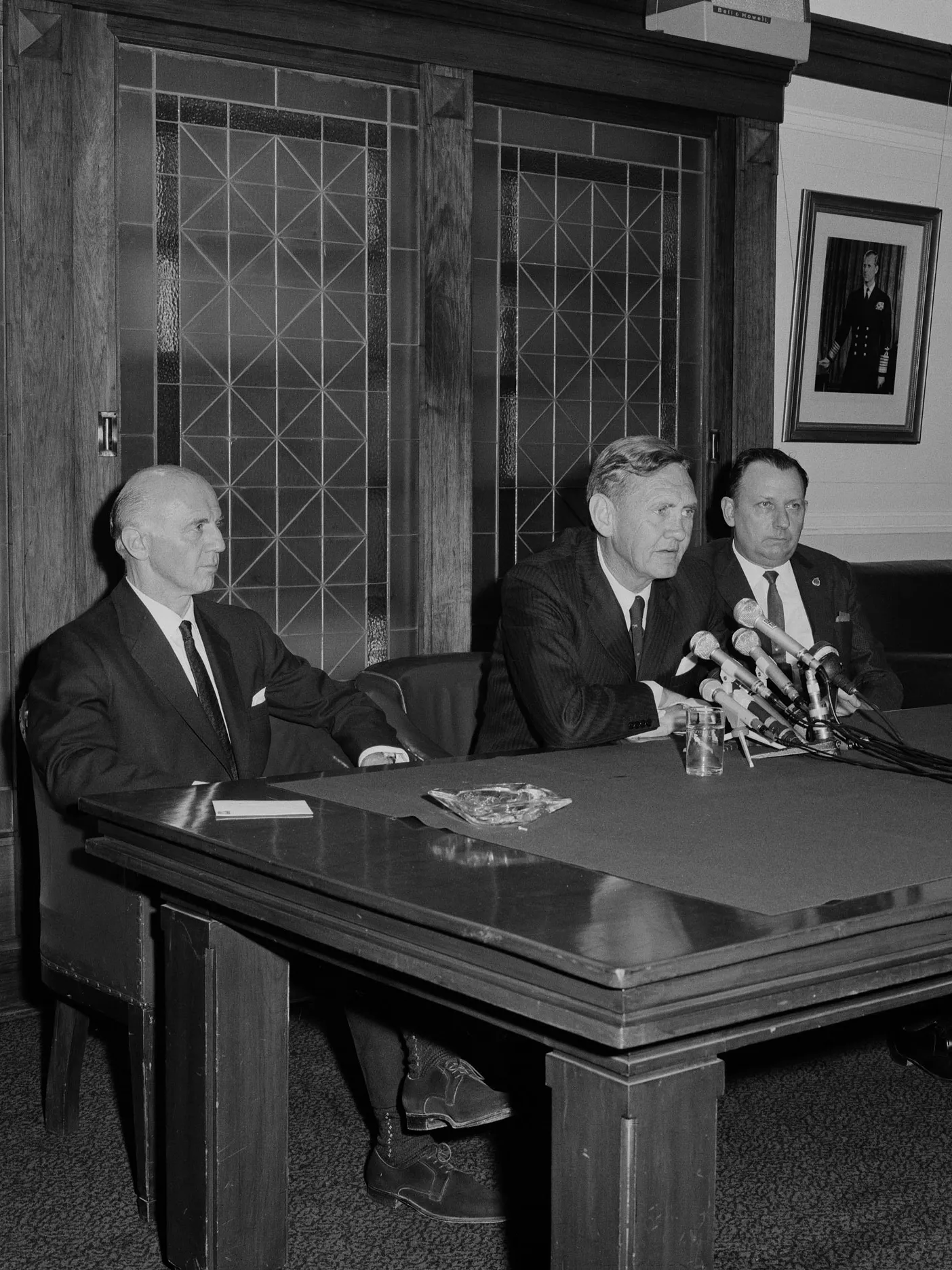 John Gorton addresses the press in the Senate Opposition Party Room on 9 January 1968 as newly elected leader of the Liberal Party following the death of Harold Holt. The next day he was sworn in as prime minister. Billy McMahon and Dudley Erwin sit beside Gorton.
Photograph NAA: A1200, L68176 Former Australian Prime Minister John Gorton and two other men sit at a table with microphones in the Senate Opposition Party Room in Old Parliament House.