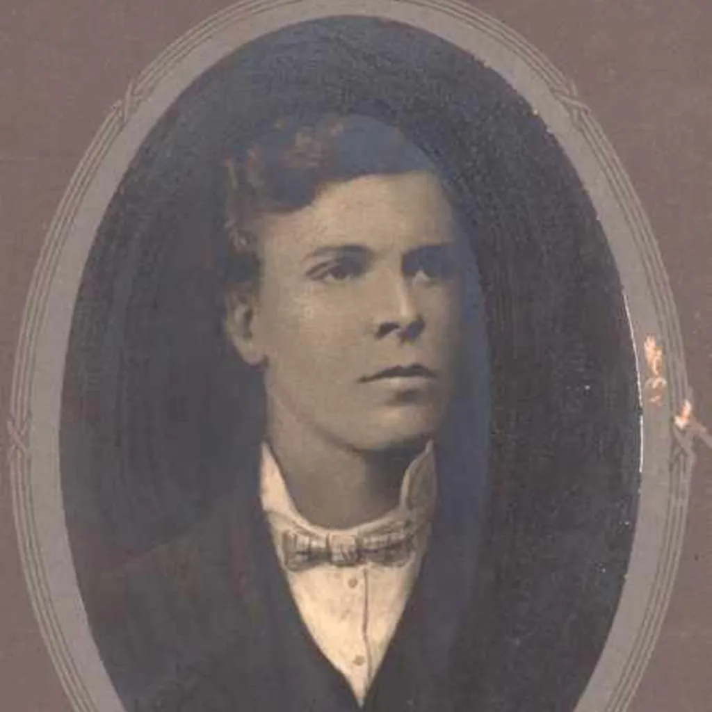 Portrait of Andrew Fisher, wearing a suit and bow tie, framed with an oval border.