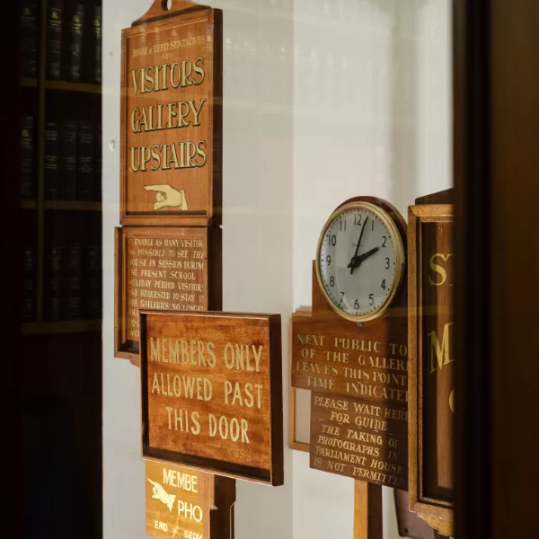 A clock and wooden signs