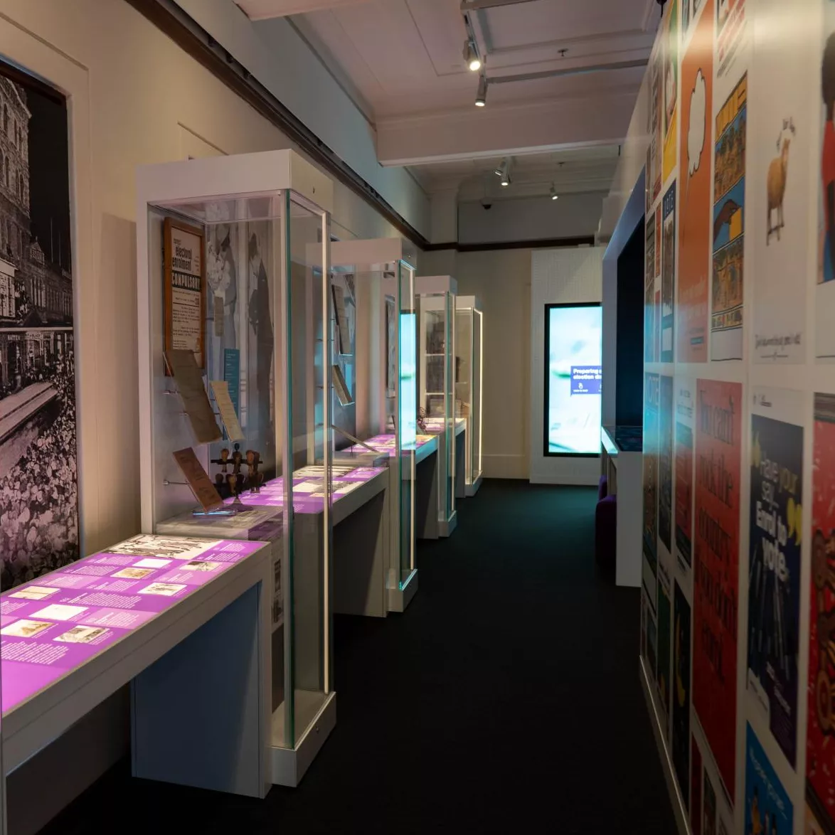 An exhibition space with glass showcases filled with objects