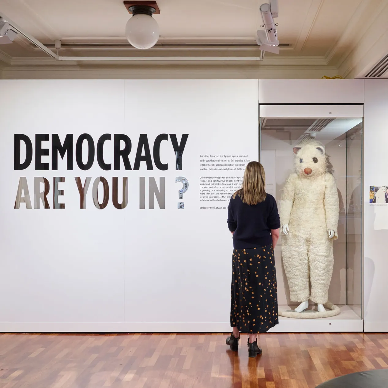 People view the Democracy Are You In exhibition featuring a giant possum costume in Old Parliament House.
