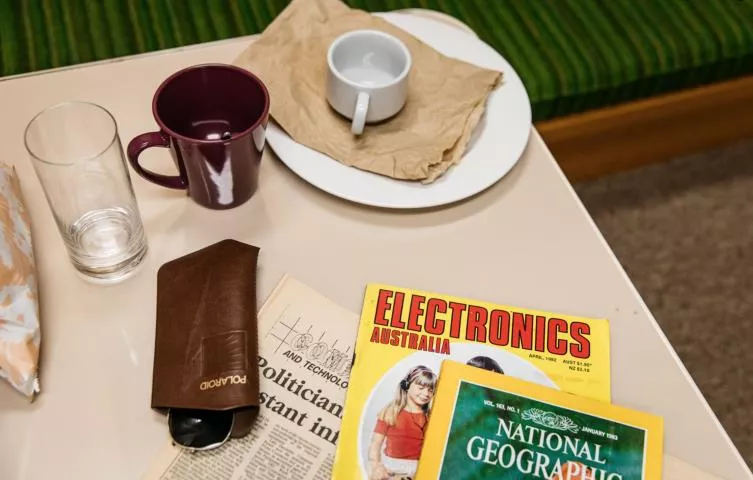 Cups and magazines on a table in the studio