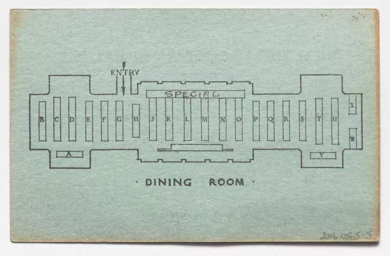 Photograph of a green ticket displaying an overlay of a dinining room with a table seating position.