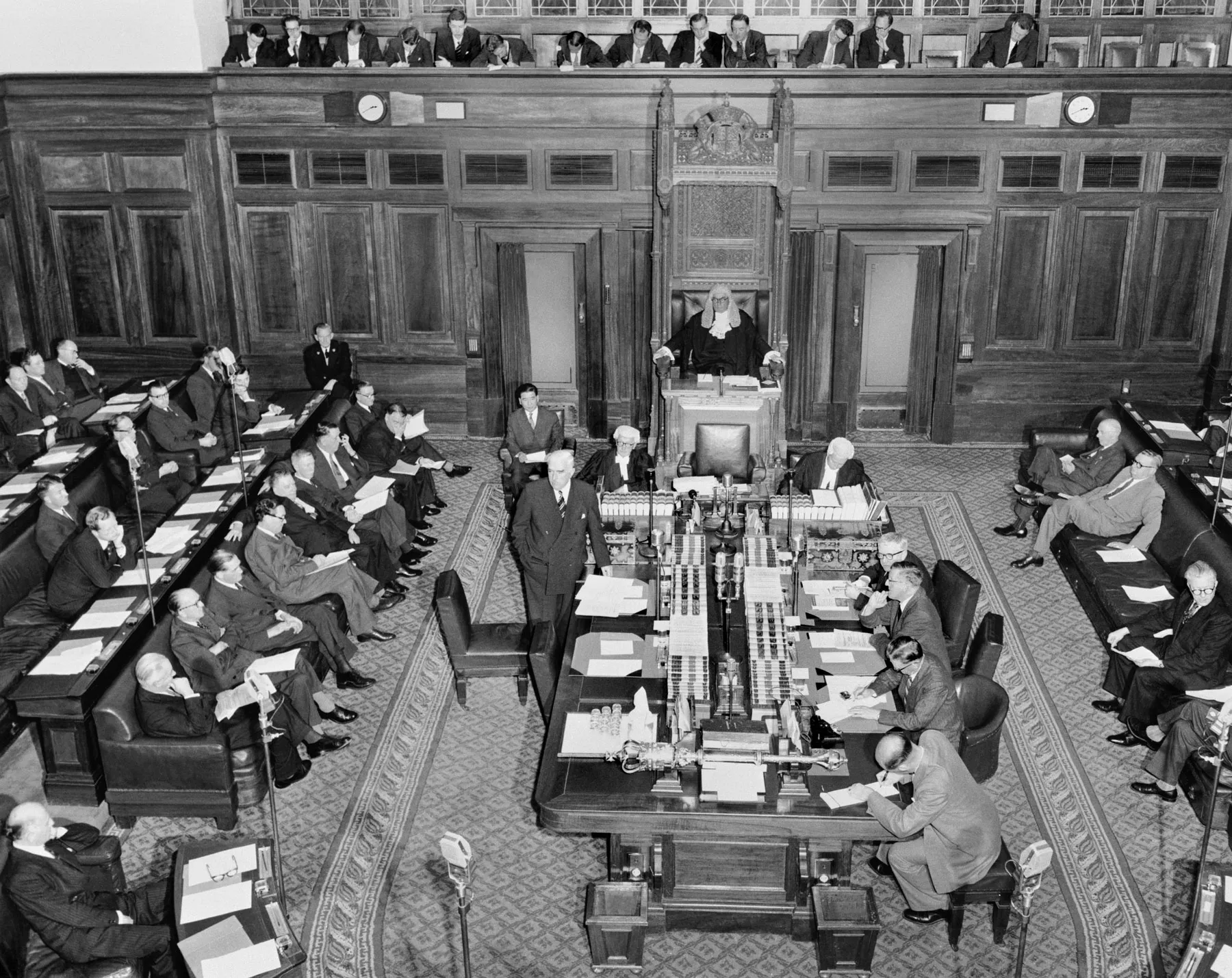 Parliamentarians sit in the House of Representatives at Old Parliament House in 1957. Sir Robert Menzies stands next to the centre table.